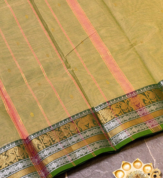 Embrace enchanting elegance with Moss Green Chettinad Cotton Saree w/ Gold & Silver Zari Border from swadeshsouq.com.