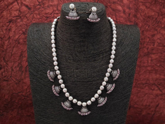 Make a royal statement with Oxidized Silver Necklace & Jhumka Set w/ Stunning Purple Pearls from swadeshsouq.com.