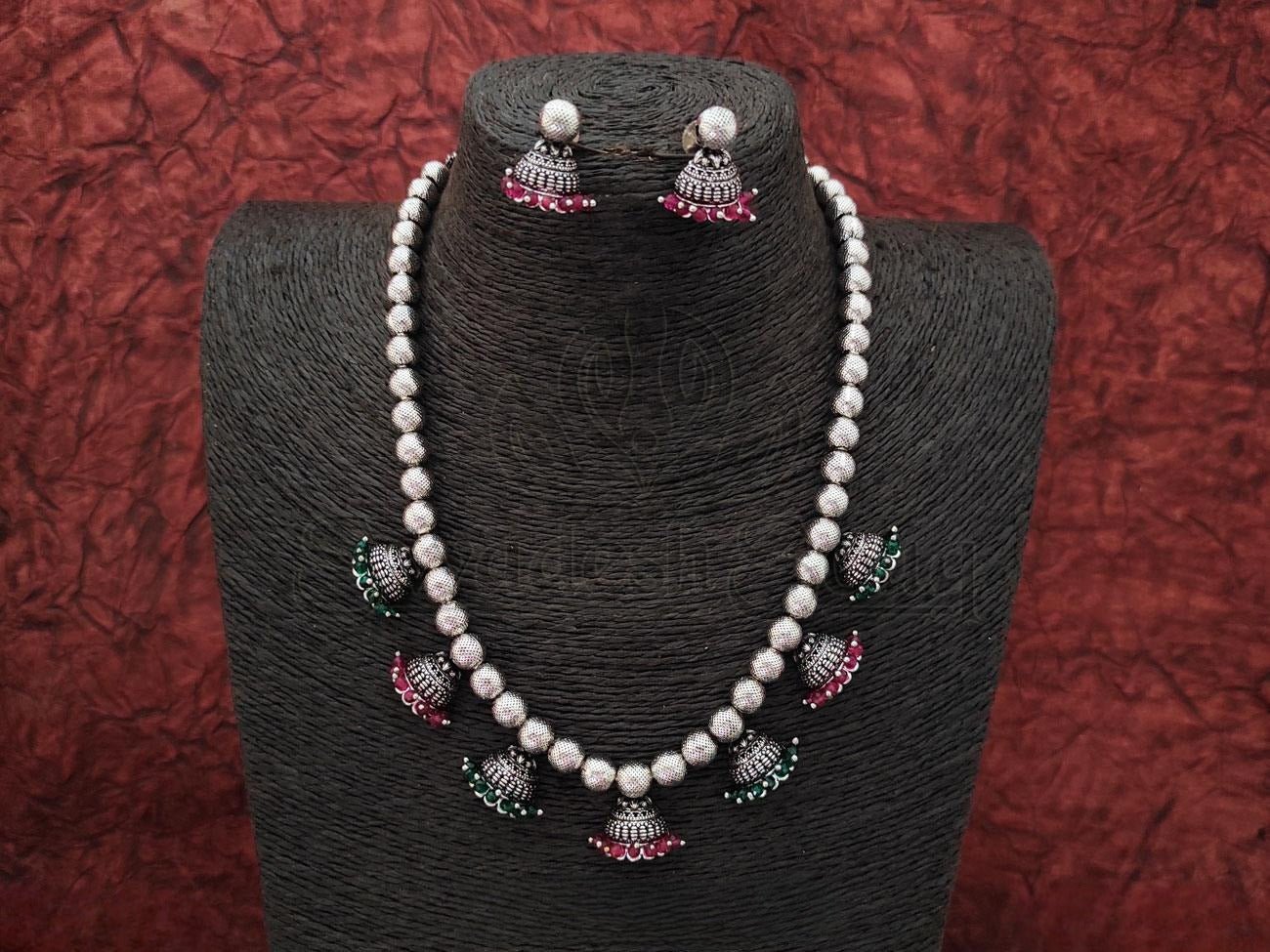 Oxidized Silver Necklace and Jhumka Set Embellished with Ruby and Emerald Pearls. - swadeshsouq.com