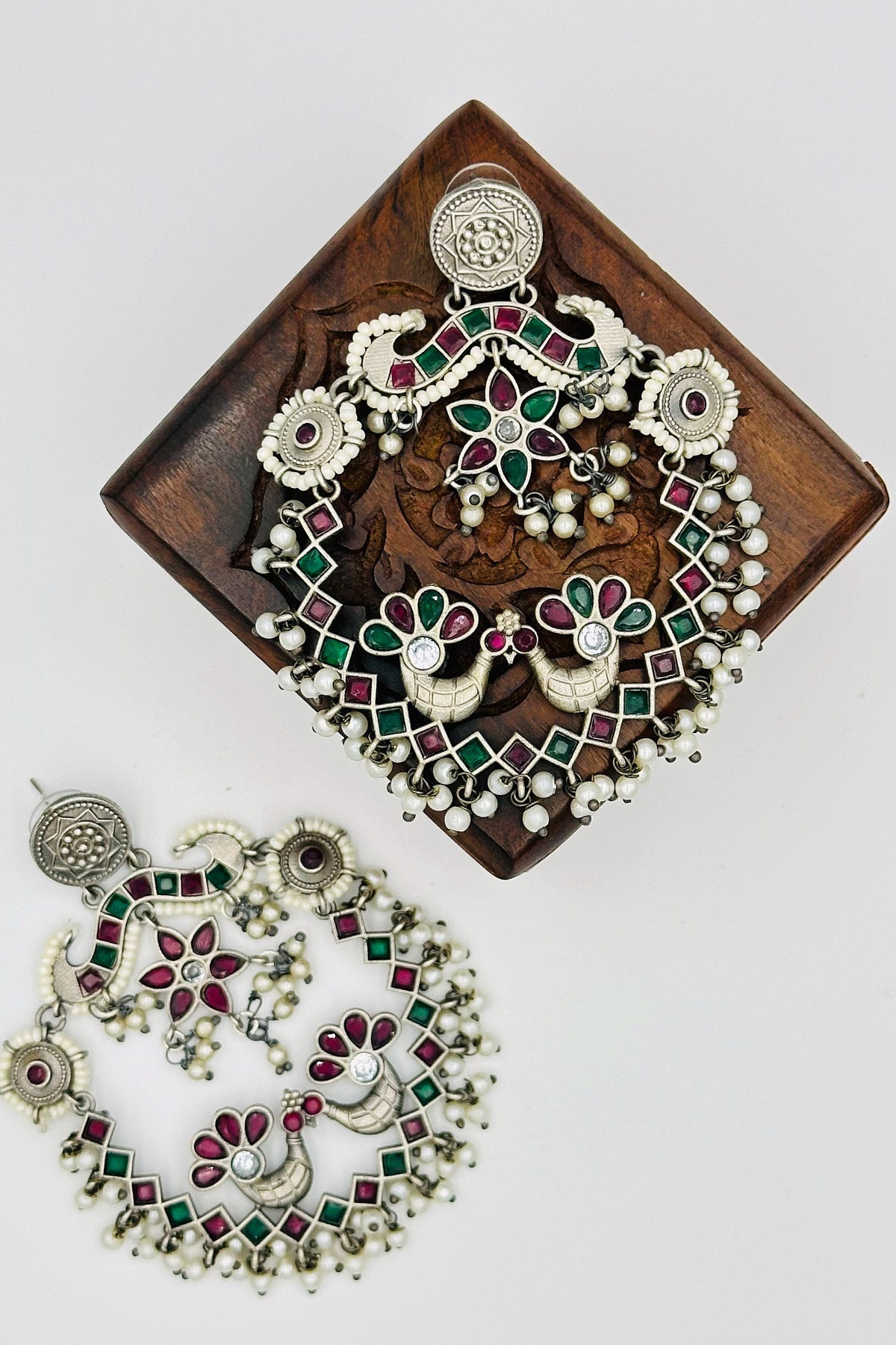 Silver Peacock Chandbali Earrings with Pearls and Red & Green Stones - swadeshsouq.com