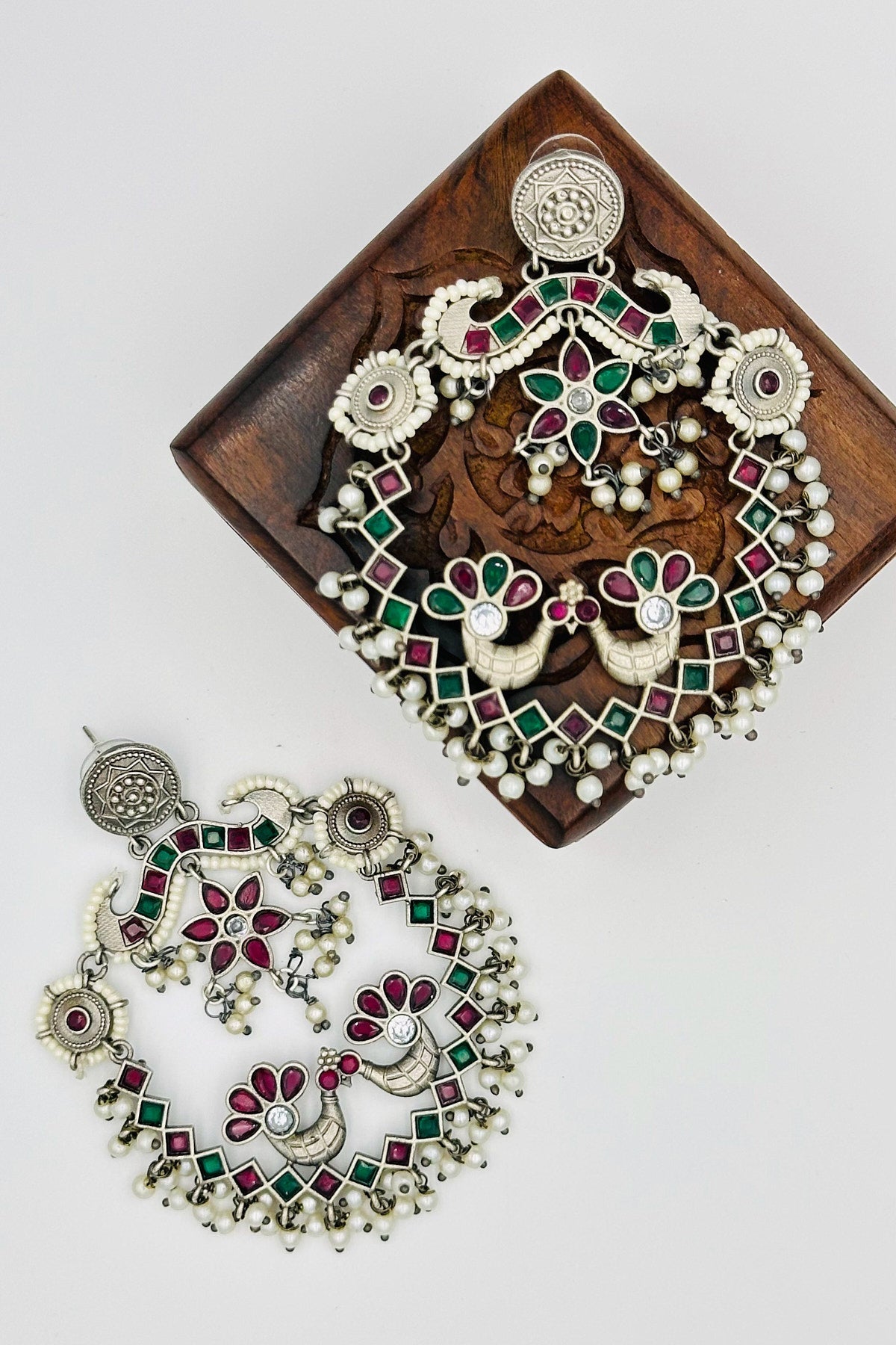 Silver Peacock Chandbali Earrings with Pearls and Red & Green Stones - swadeshsouq.com